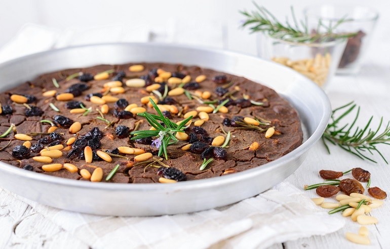 Castagnaccio, a traditional cake made with chestnut flour, pine nuts, sultanas and walnuts (© Travelbook | Dreamstime.com)