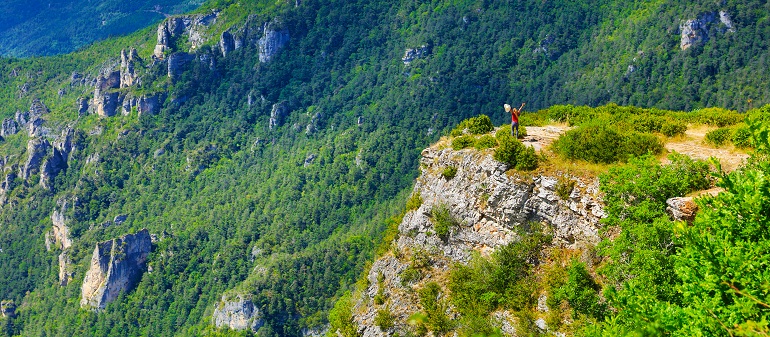 Woman hiking over a canyon in the Cévennes National Park (© Margouillat | Dreamstime.com)