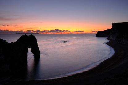 Durdle Door at sunset ( Bob Berry | iStockphoto.com)