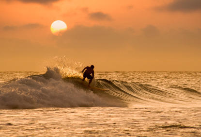 Surfer at sunset, Newquay (&copy; Brett Charlton | iStockphoto.com)